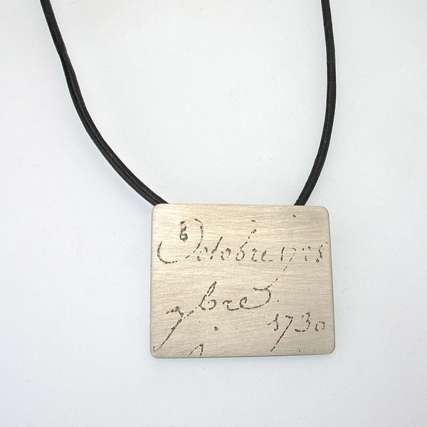 Manu Scriptum Pendant on black leather cord