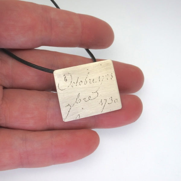 Manu Scriptum Pendant on black leather cord