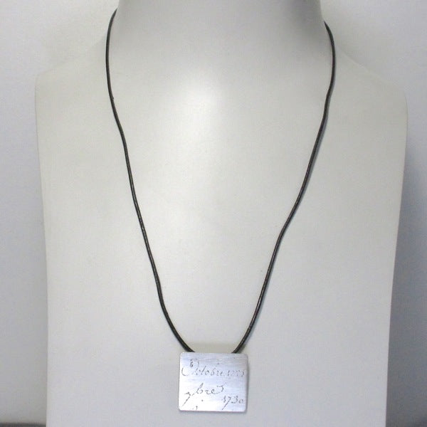 Manu Scriptum Pendant on black leather cord