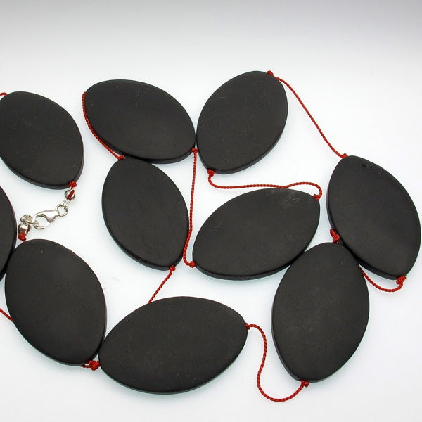 Matte onyx beads on a long silk necklace