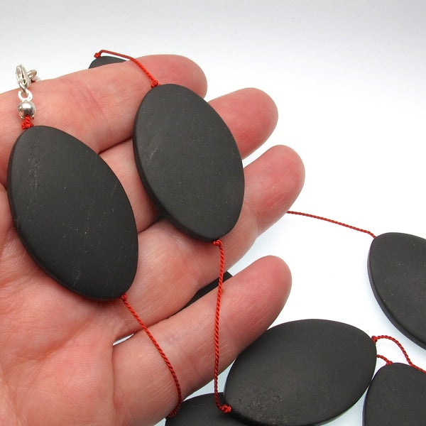 Matte onyx beads on a long silk necklace