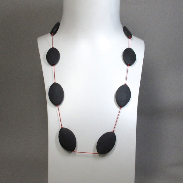 Matte onyx beads on a long silk necklace