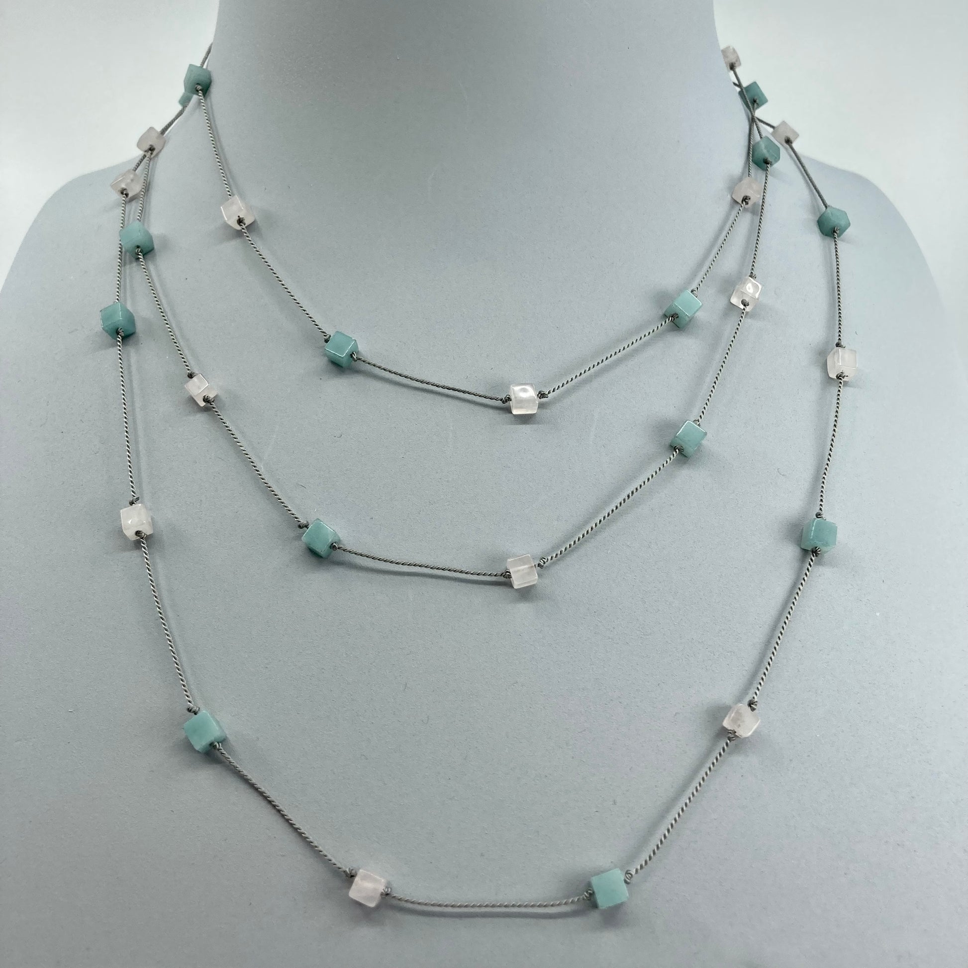 Amazonite  rose quartz cubes threaded on a silk cord tripled over bust