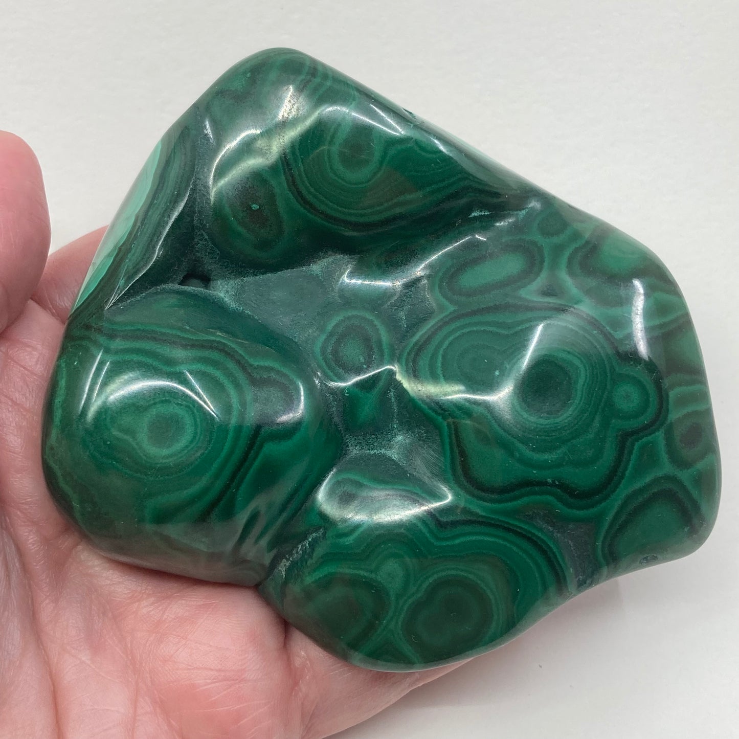 Malachite polished freeform viewed on hand