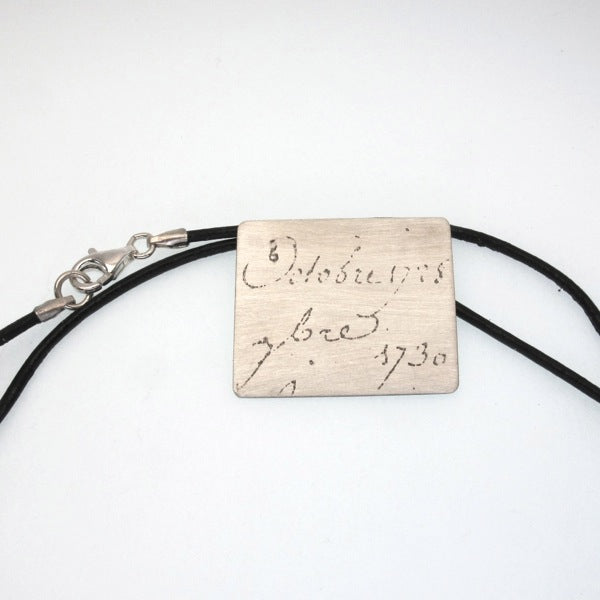 Manu Scriptum  Pendant on black leather cord